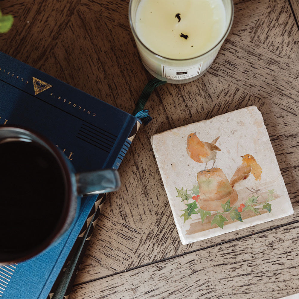 A square marble coaster featuring a Christmas design of robins and holly.