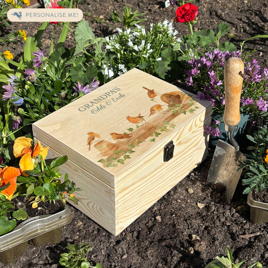 Medium wooden pine gift box, The perfect Personalised keepsake, memory box, storage box with a rabble of robins playing on a greenhouse shelf covered in Ivy and plant pots, some of the robins have knocked over the plant pots leaving soil on the self.  The design  features our classic gentle watercolour style. keepsake, storage, small items to keep safe in a beautiful box