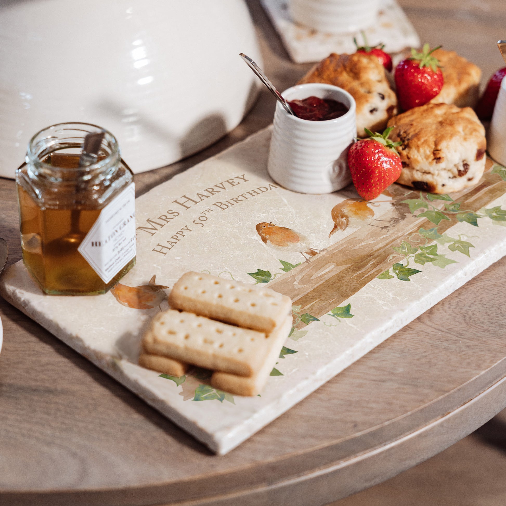 A personalised marble sharing platter with a robins watercolour design. Create a personalised serving platter, trivet or cheeseboard as a luxury gift.