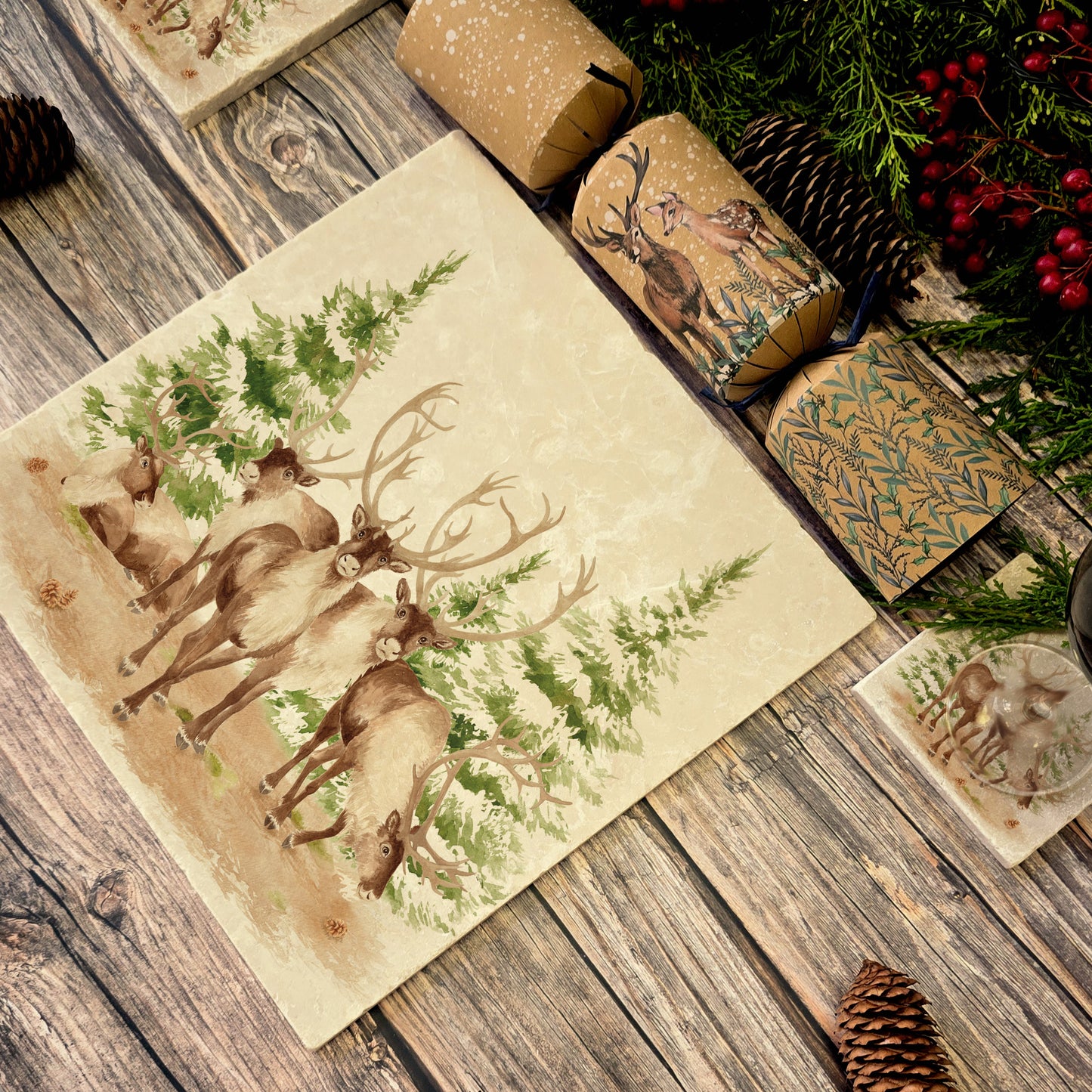 The Reindeers rest design features reindeer appearing from an opening in the wintery snowy forest. 