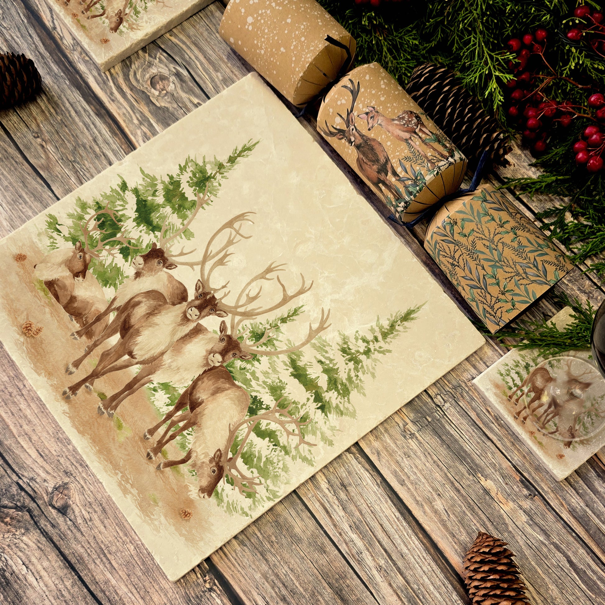The Reindeers rest design features reindeer appearing from an opening in the wintery snowy forest. 