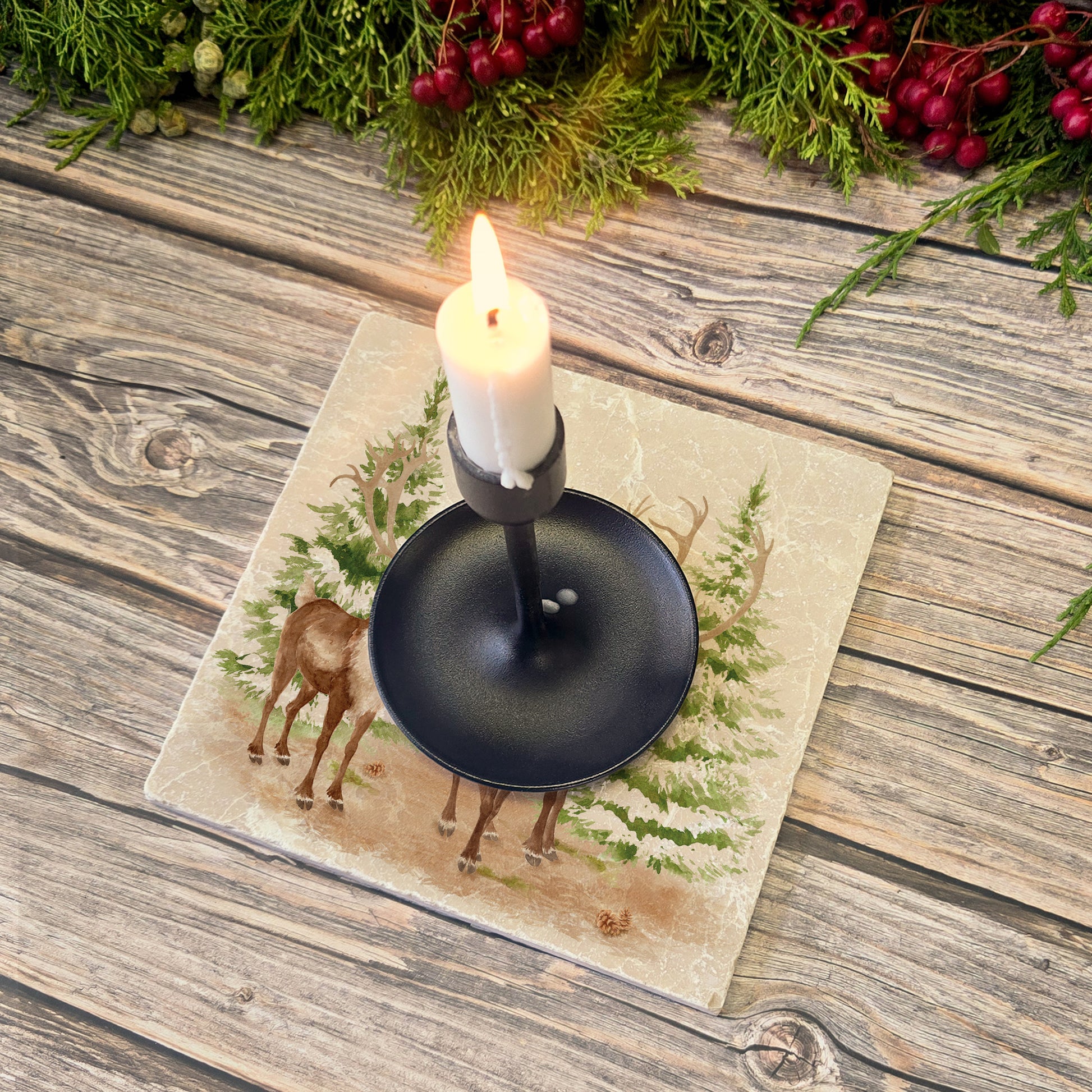 The Reindeers rest design features reindeer appearing from an opening in the wintery snowy forest. 