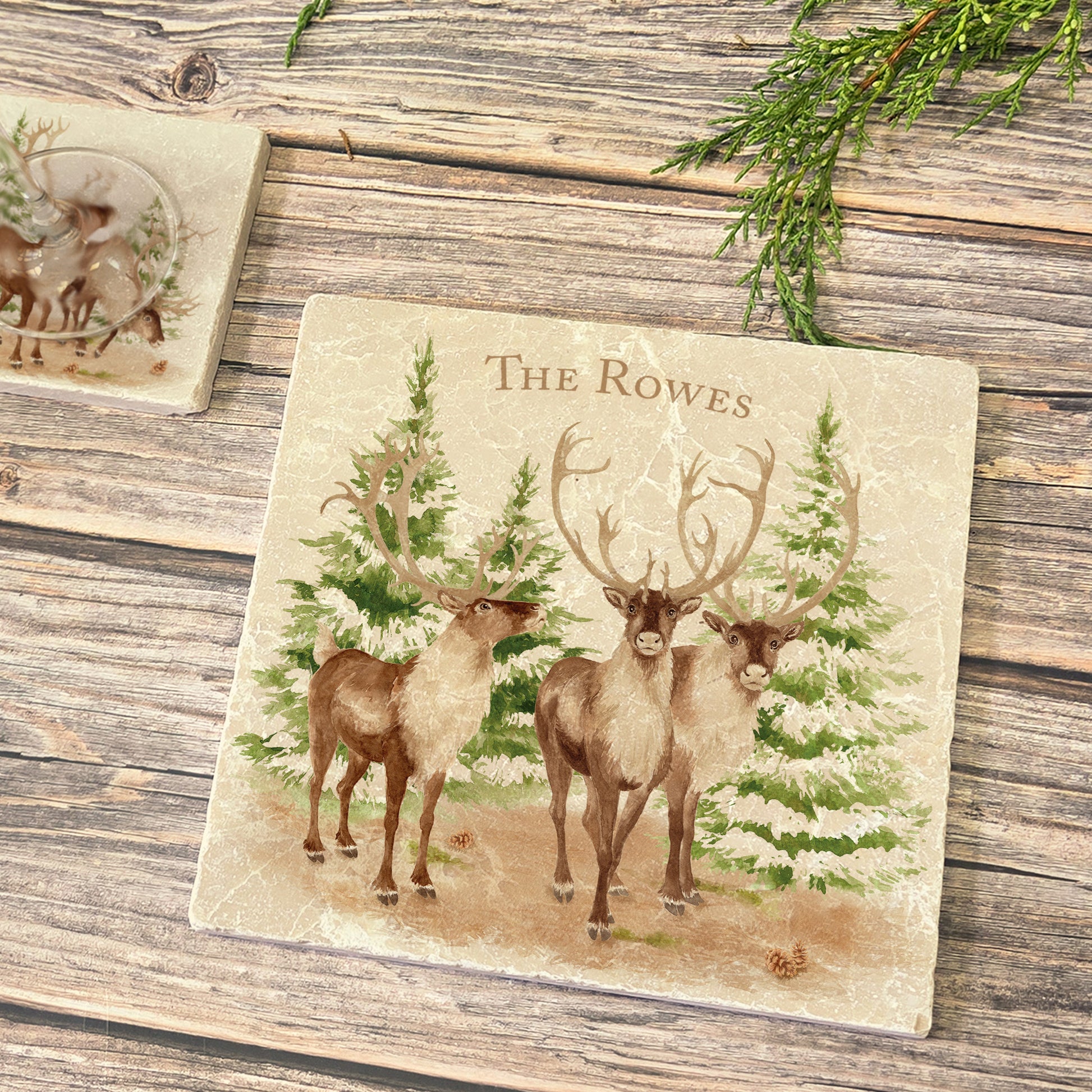 The Reindeers rest design features reindeer appearing from an opening in the wintery snowy forest, perfect personalisation features.