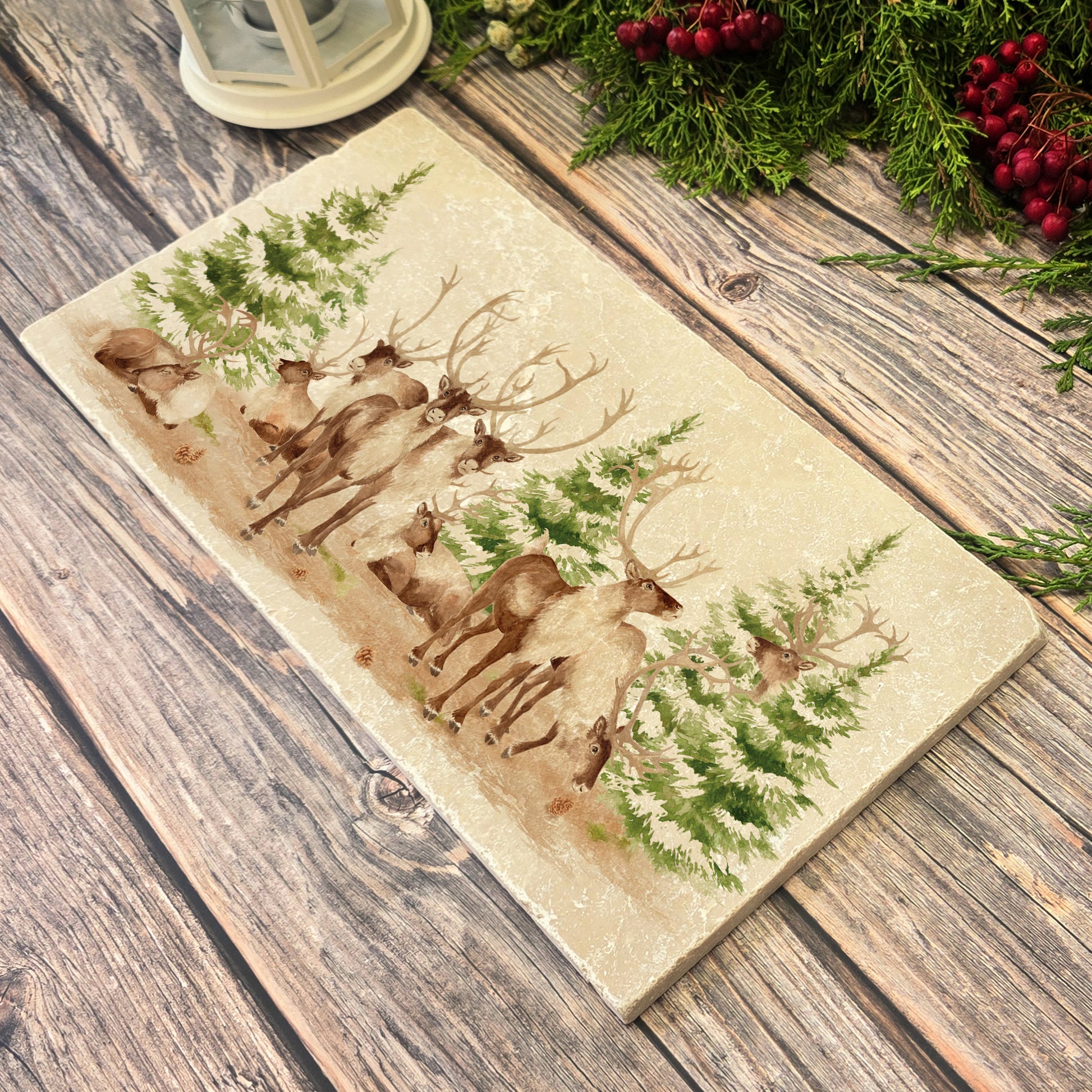 The Reindeers rest design features reindeer appearing from an opening in the wintery snowy forest. 