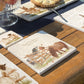 A medium personalised square multipurpose marble chopping board propped up on a country kitchen worksurface, featuring a watercolour design of two cheeky Shetland ponies stealing apples.