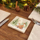 Set of four square marble coasters featuring a winter forest illustration with a fox family and evergreen trees in the snow.