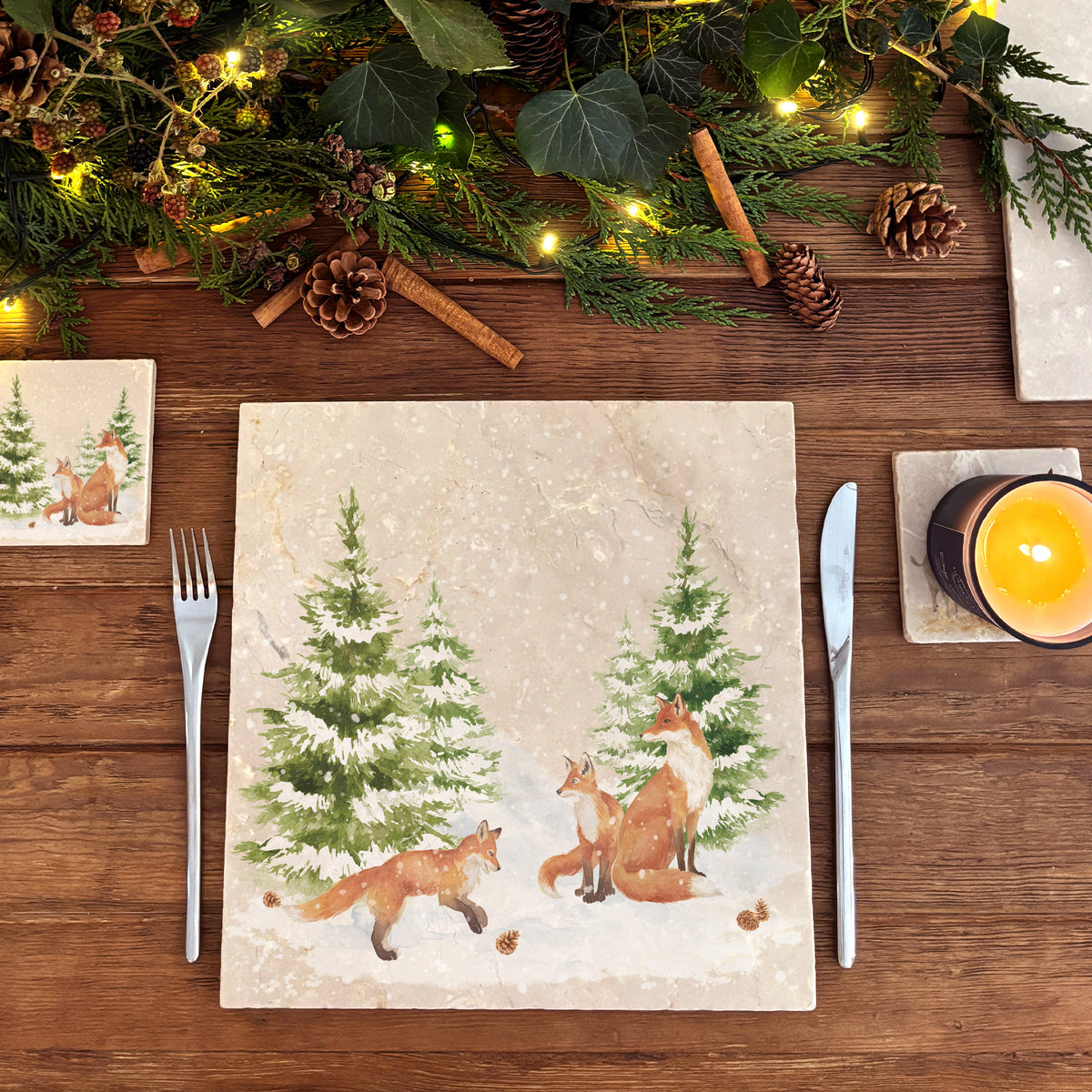 A large square marble platter featuring a forest scene with a fox family playing in the snow.