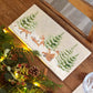 A rectangular marble sharing platter with a winter scene of a family of foxes and fox cubs playing in the snow.