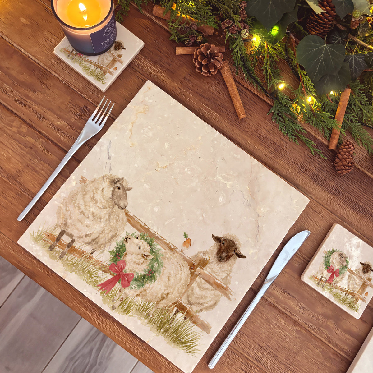 A large square marble platter featuring a watercolour illustration of a farmyard scene of sheep in the snow wearing a Christmas wreath.