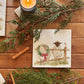 A medium marble platter featuring a watercolour illustration of a farmyard scene of sheep in the snow wearing a Christmas wreath.