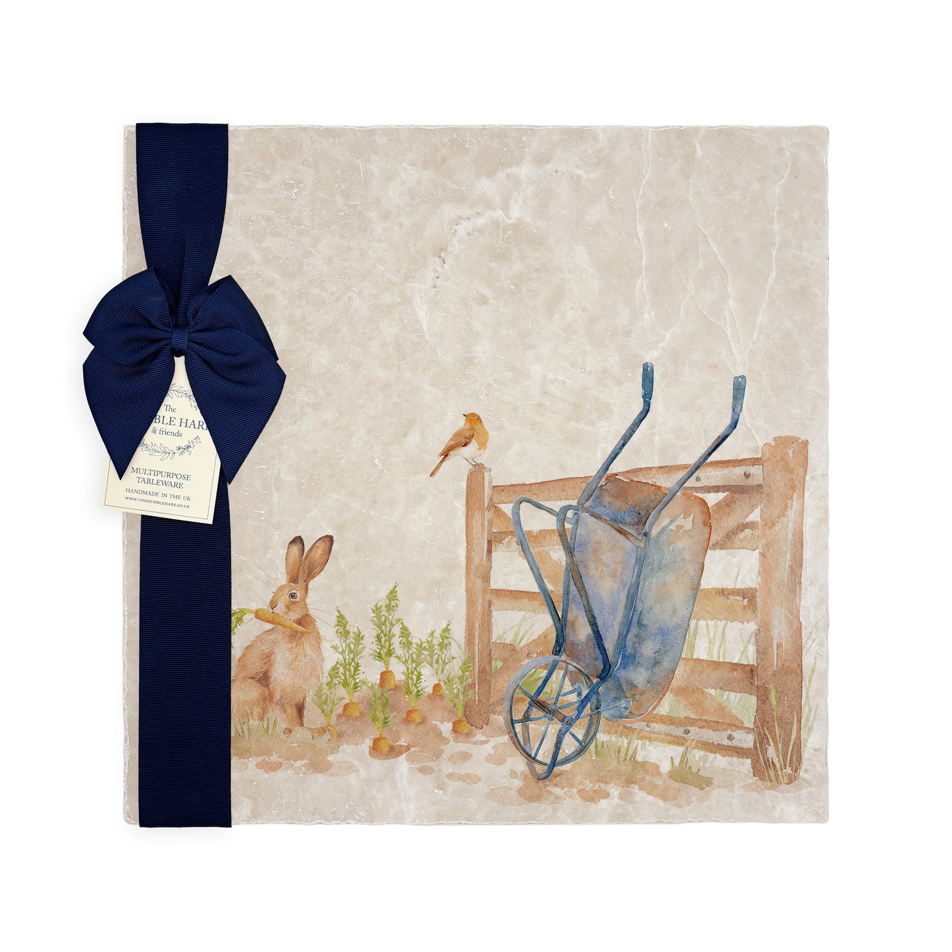 A large multipurpose marble platter with a watercolour vegetable patch design, packaged with a luxurious dark blue bow and branded gift tag.