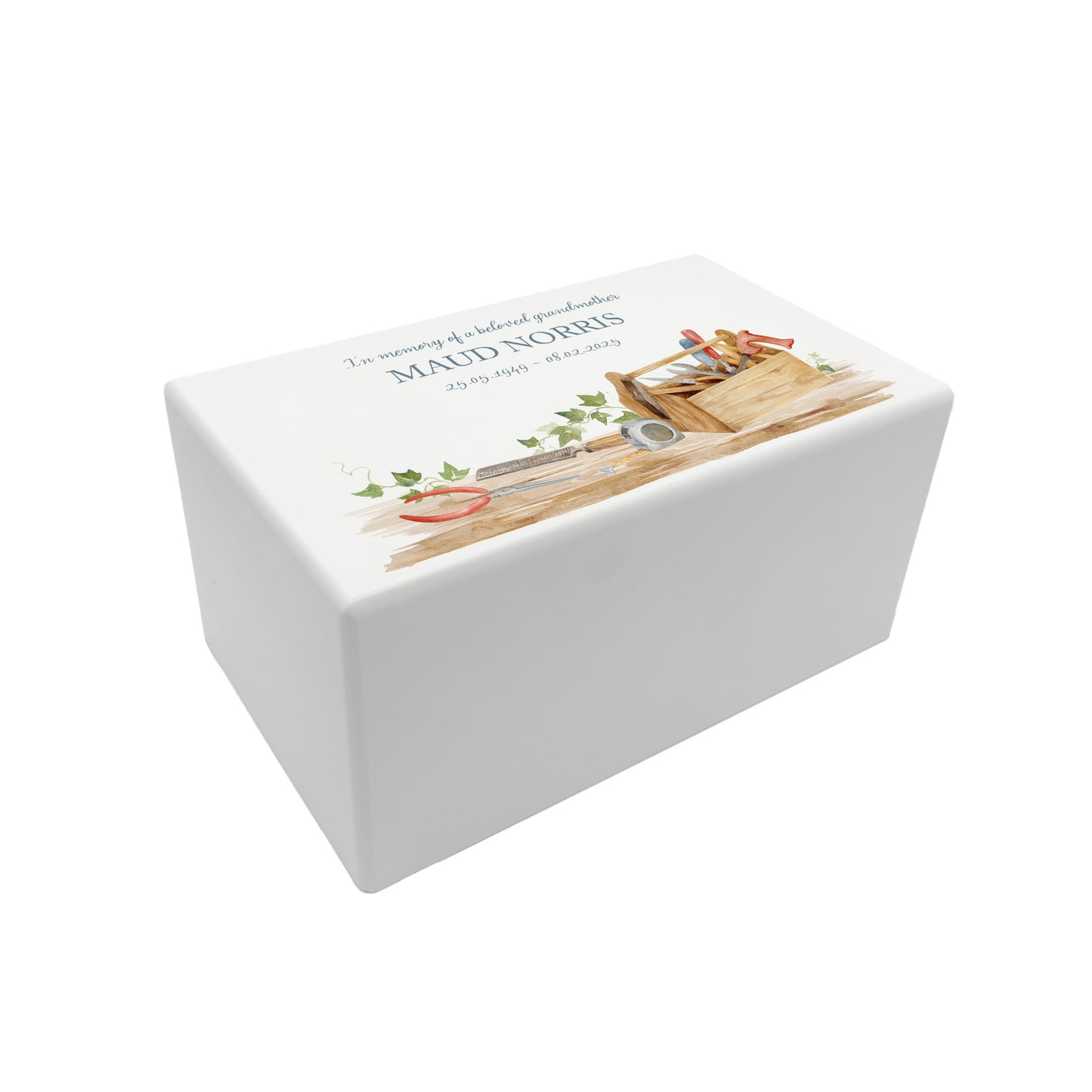 A beautifully crafted solid wooden urn, finished in white with a soft watercolour design Dads, Grandads, uncles, Brothers tool box, Thoughtfully made for either display or burial, this personalised urn can be customised to create a meaningful memorial. Perfect for holding ashes of a loved one or a beloved pet, it serves as a comforting tribute and keepsake.
