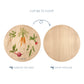 Wooden cutting board with a vegetable pattern illustration on one side and plain wood on the other, with text indicating which side to display and which to chop.