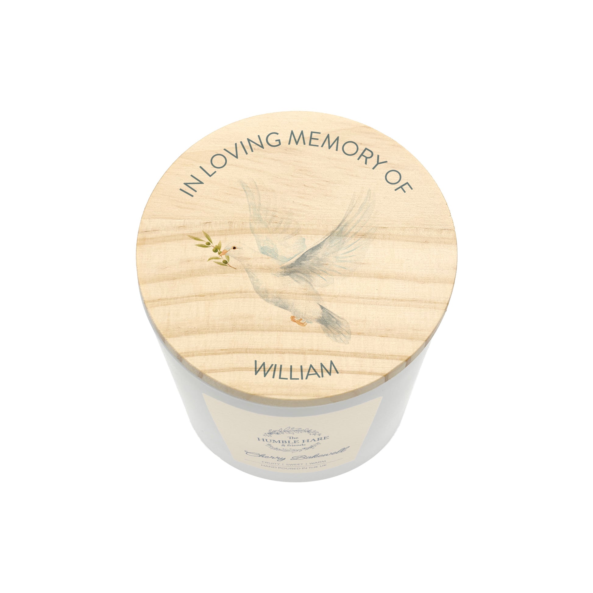 A memorial jar candle with a light wood lid with a dove holding an olive branch and the text 'IN LOVING MEMORY OF WILLIAM', shown on a white background.