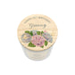 A personalised white glass candle jar with a light wood lid with an illustration of a bunch of blue and pink hydrangeas and the words Happy 70th Birthday Granny.