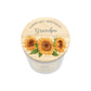 A personalised white glass candle jar with a light wood lid with an illustration of a sunflower and the words Happy 80th Birthday Grandpa.