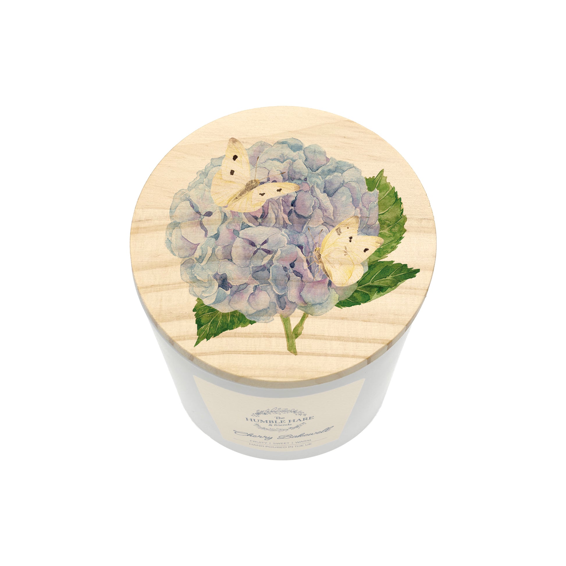 A white glass candle jar with a light wood lid with an illustration of a blue hydrangea and cream butterflies.