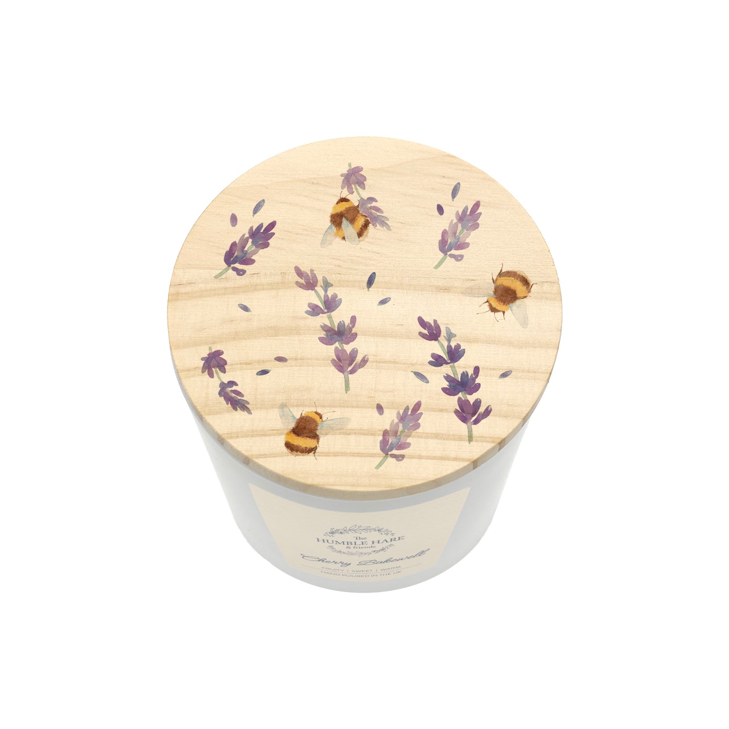 A  white glass candle jar with a light wood lid with an illustration of lavender flowers and bumblebees.