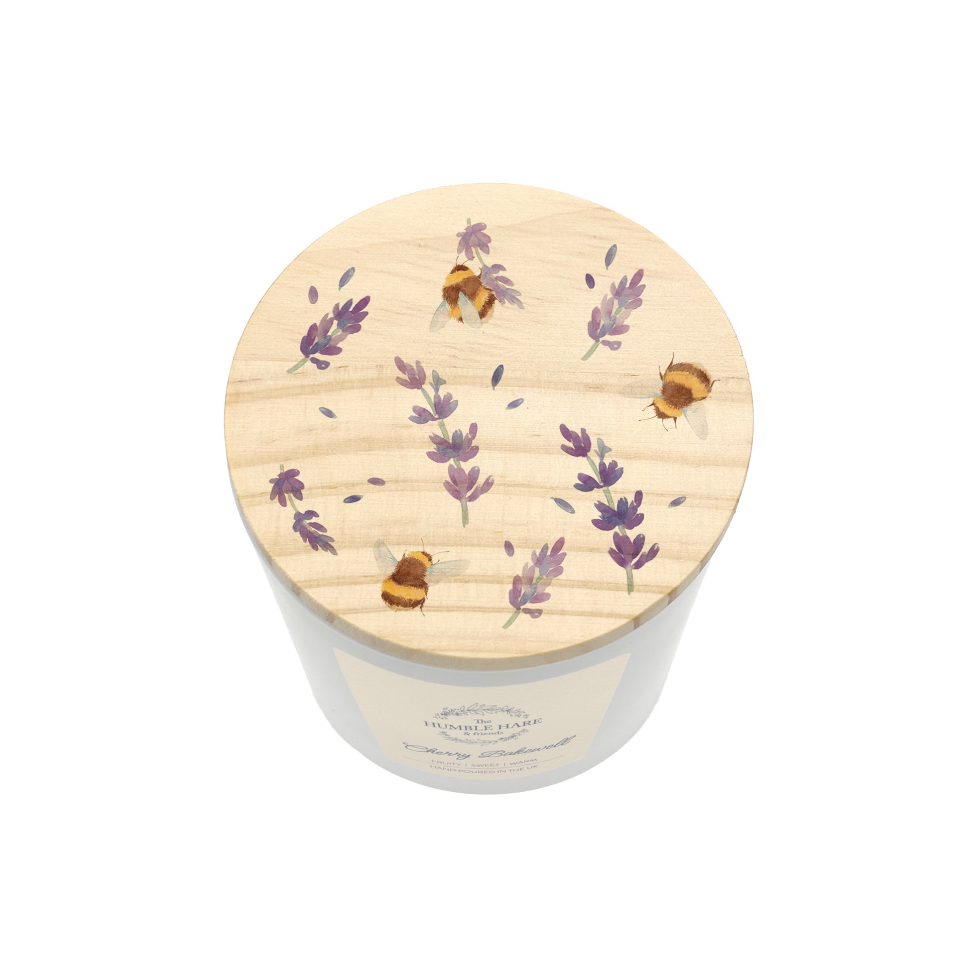 A  white glass candle jar with a light wood lid with an illustration of lavender flowers and bumblebees.