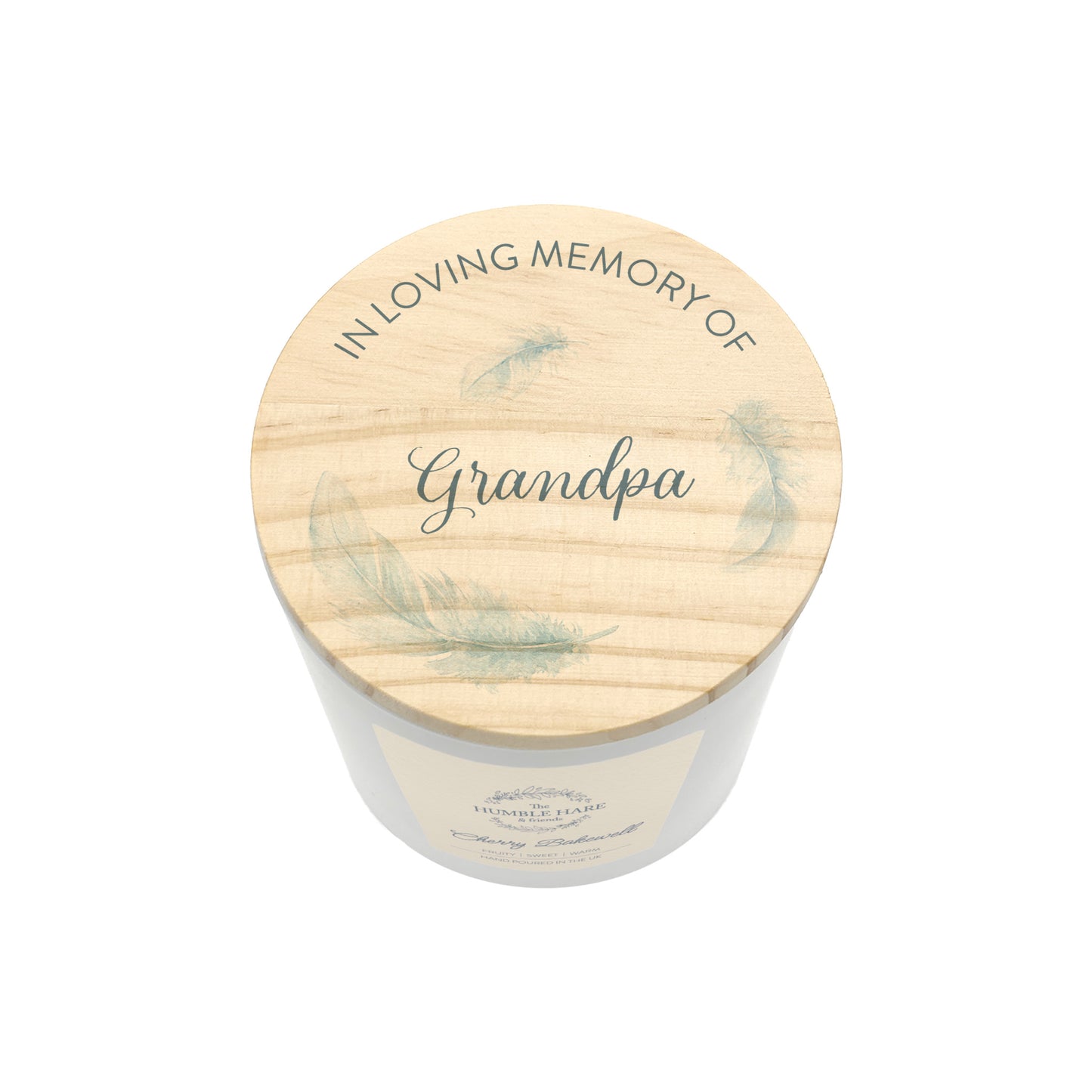 A personalised jar candle with a light natural wood lid with 'IN LOVING MEMORY OF Grandpa' and delicate feather illustrations, shown on a clean white background.