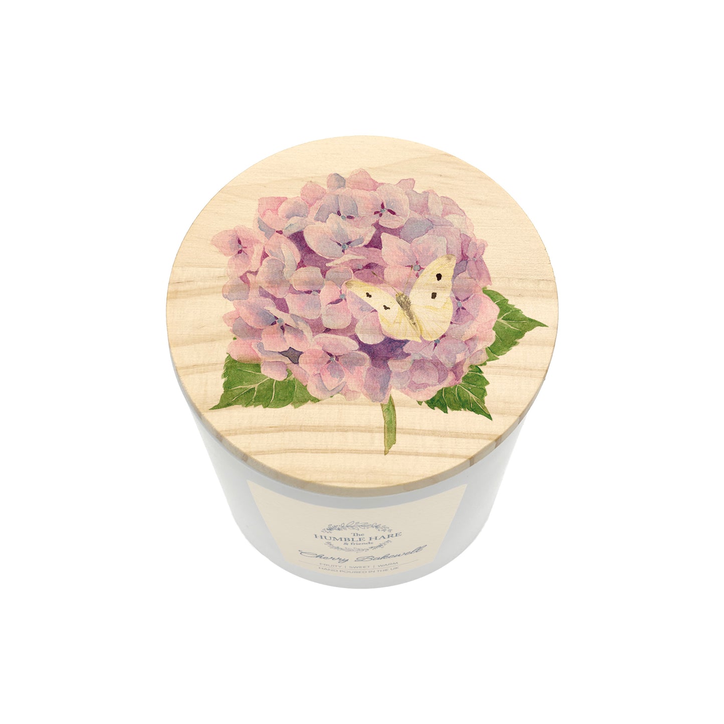 A white glass candle jar with a light wood lid with an illustration of a pink hydrangea and a cream butterfly.