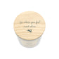 A jar candle with a light natural wood lid featuring the quote  'Go where you feel most alive' and a small hare silhouette, shown on a plain white background.