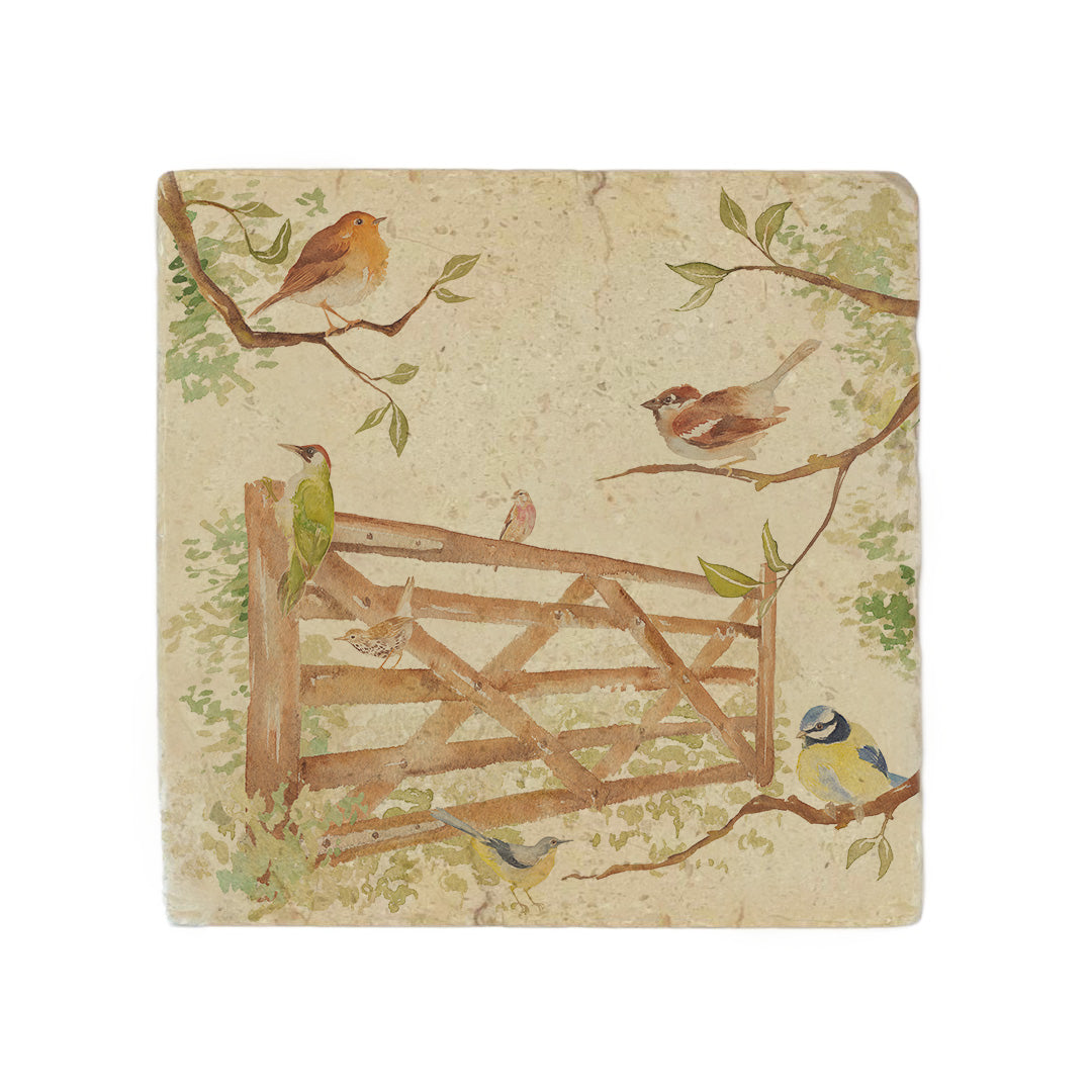 A square cream marble placemat featuring a watercolour countryside animal design of British garden birds in the hedgerow surrounding a paddock gate.